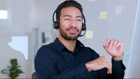 Male-call-center-agent-talking-on-headset