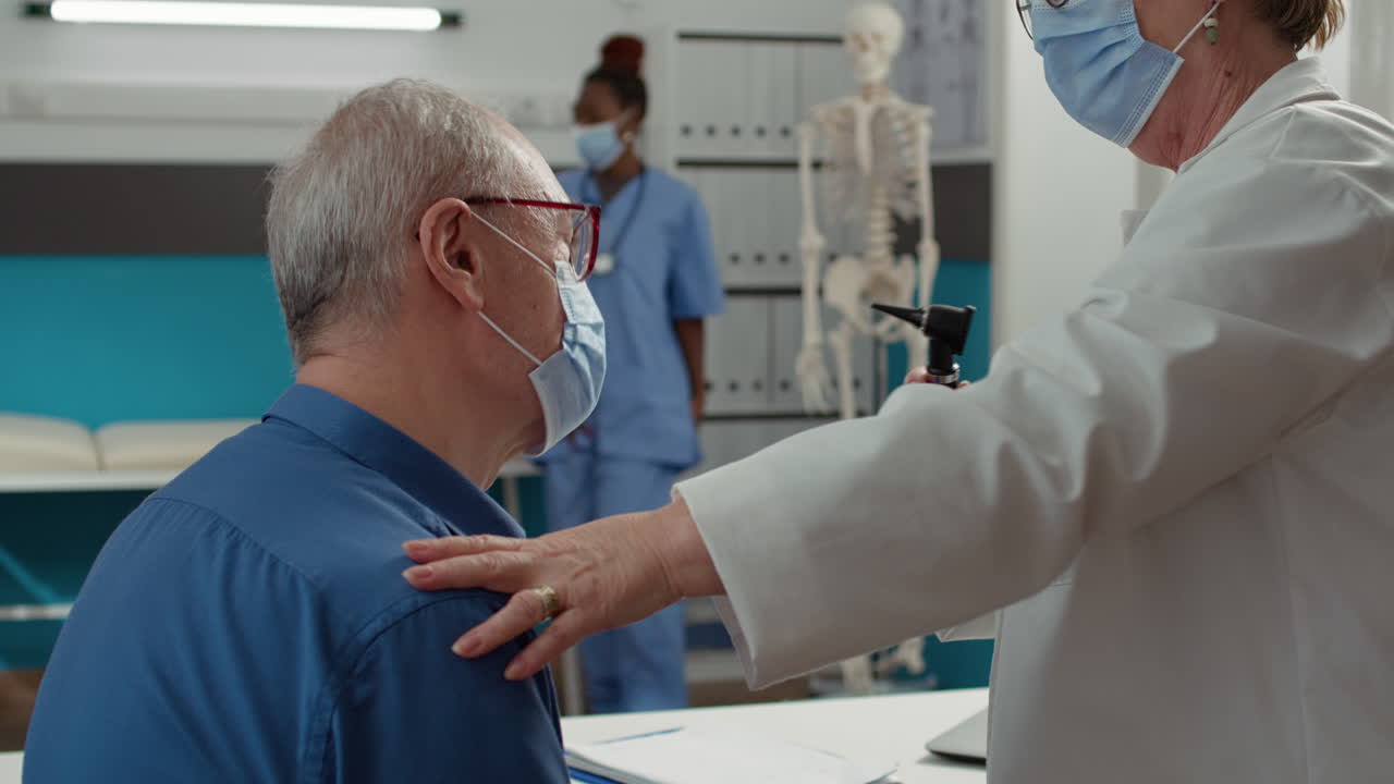 Medic using otoscope instrument to do ear examination