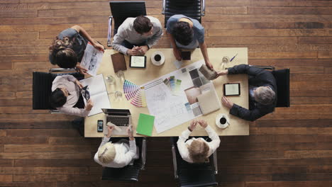 business people meeting around boardroom table discussing textiles