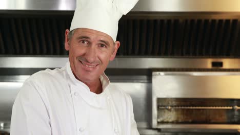 smiling chef slicing vegetables