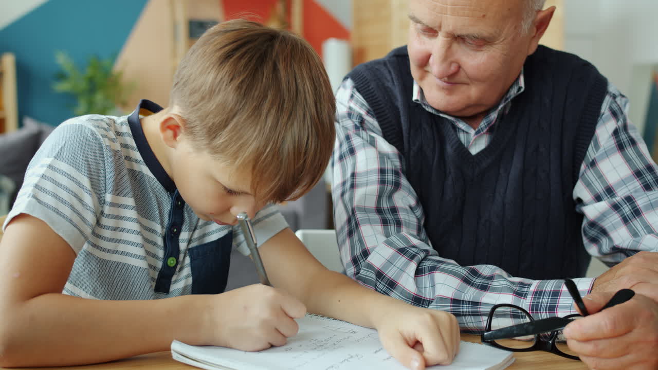Grandfather helping grandson with homework