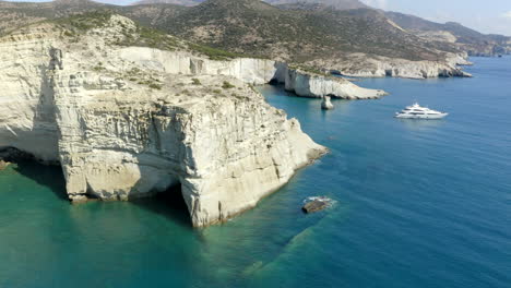 klefitko beach and white cliffs drone aerial shot over the blue waters and dramatic coastline of the greek island of milos, greece in 4k