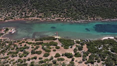 high angle aerial overview of ancient underwater ruins in turquoise green blue water in deep channel, aperlai turkey