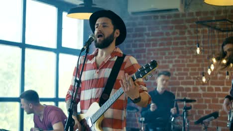 singing guitarist in hat