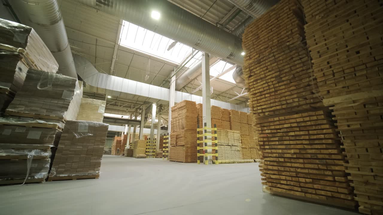Large Stacks of Lumber in a Spacious Industrial Warehouse