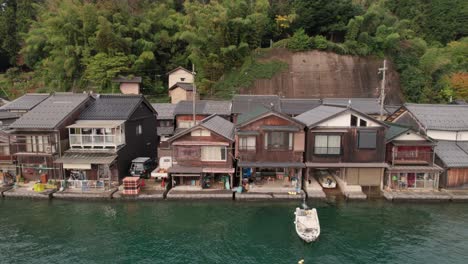 aerial panoramic drone of boathouses at japanese kyotango coastline beach houses in japan summer travel destination