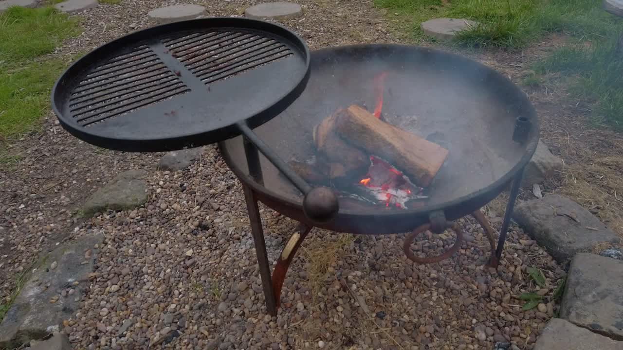 barbecue smouldering and smoking on stone ground