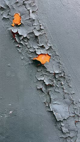 cracked and peeling paint on metal surface