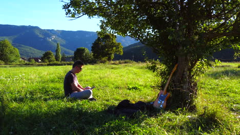 man relaxing in the nature under an apple tree