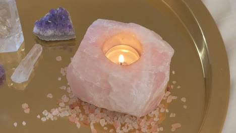 rose quartz candle on a gemstone tray