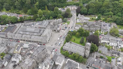 Aerial-view-of-Tavistock-town-centre-showcasing-historic-buildings-and-lush-greenery,-Devon,-UK