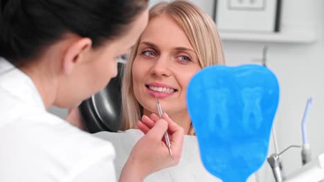 dentist examining woman's teeth in dentist's office