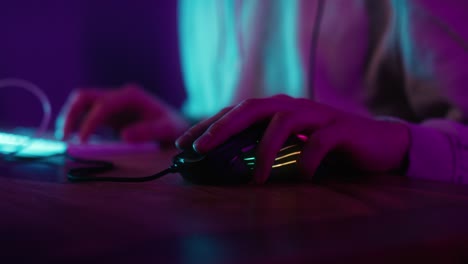 detail of computer mouse used by gamer at night