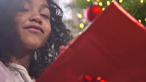 girl examining christmas present