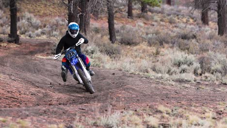 cinematic shot of dirt bike rider on a forest single track trail