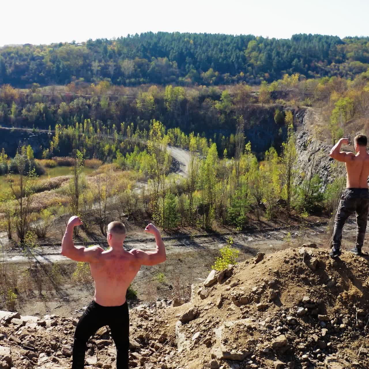 . Athletic men posing with muscles. Aerial view of handsome bodybuilders with perfect muscular body posing outdoors