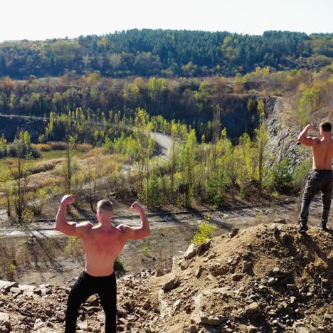 . athletic men posing with muscles. aerial view of handsome bodybuilders with perfect muscular body posing outdoors