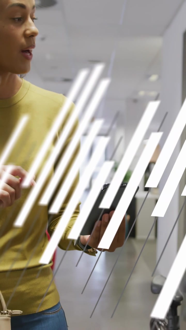 Vertical video: Woman tapping phone, gesturing at glass board in office, animated bars aiding pitch