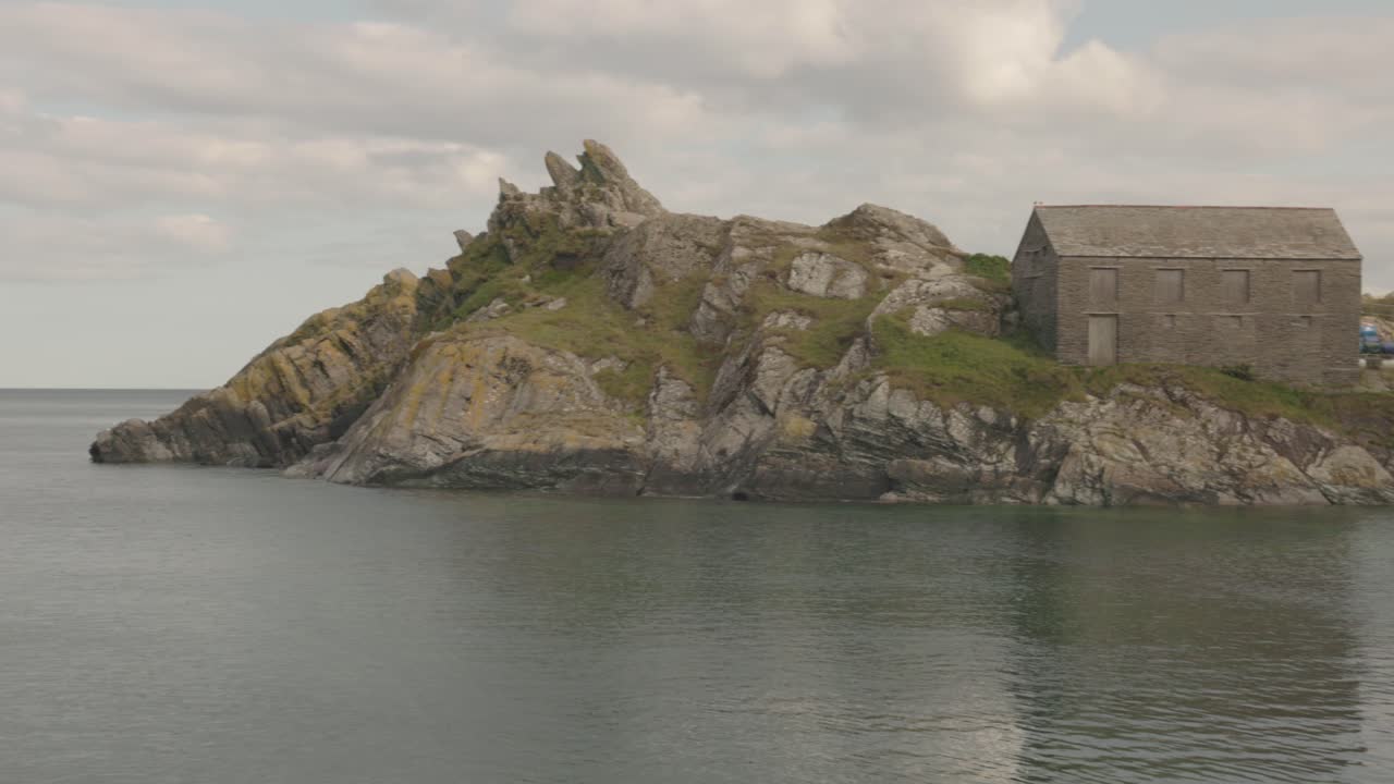 panning shot of boats anchored in the beautiful village of Polperro in Cornwall