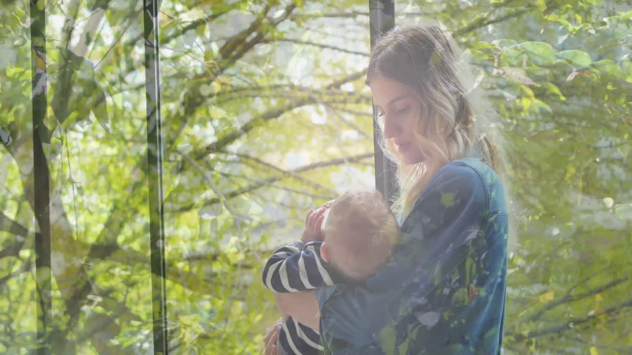 Animation von Bäumen im Sonnenschein über einer Mutter mit Baby, das Milch trinkt