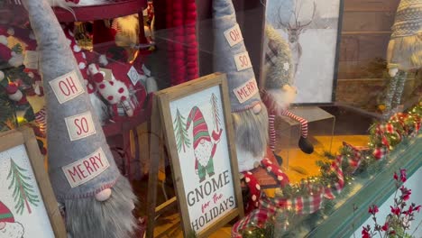 glass store window with christmas gnome decorations in the city of ashland, oregon, usa