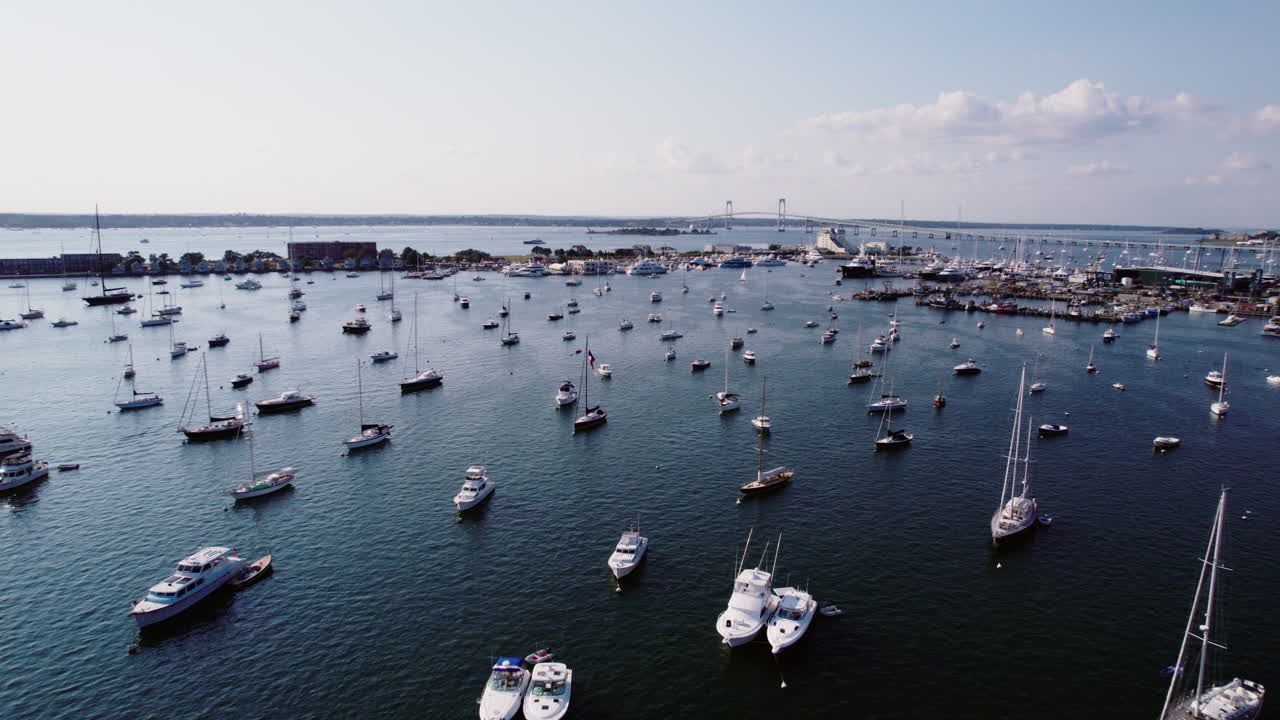 A drone shot of Newport, Rhode Island, USA, flying over the harbor with a straight-down view, capturing boats moving through the water. Perfect for maritime, travel, and aerial video projects.