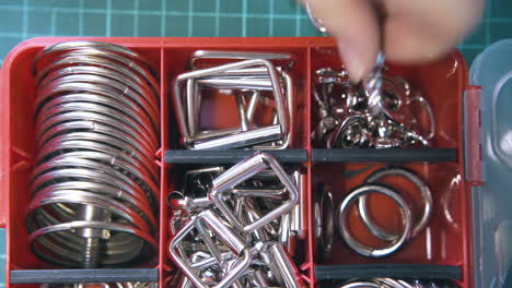 Professional person hand takes silver accessories closeup