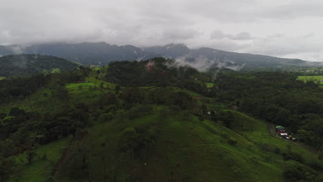 aerial of rural costa rica countyside with foggy mountains in distance, 4k