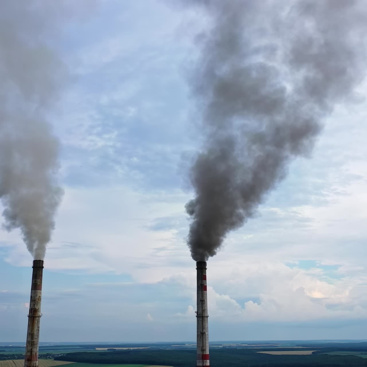 Pipes Throwing Smoke In The Sky. Industrial zone with large smoke from the factory pipes