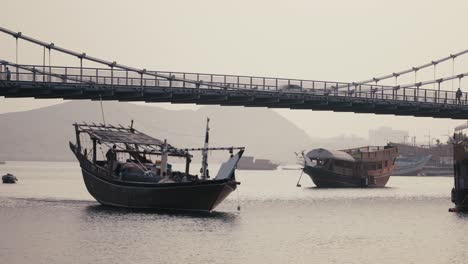 Ship-gracefully-passing-under-a-bridge