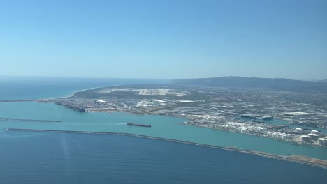 pov aerial view of barcelona airport and harbor as seen by the pilots in a real time approach