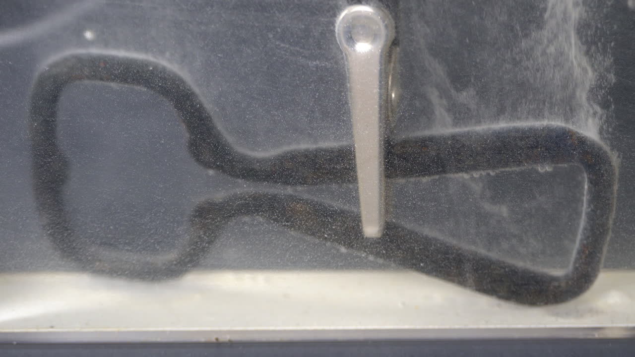 Corroded bottle opener is electrolytically cleaned with electricity