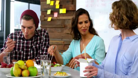 Business-executives-interacting-with-each-other-while-having-lunch