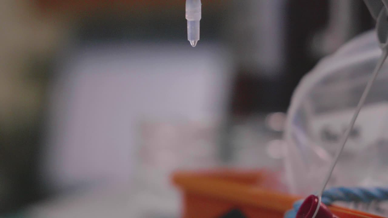 Liquid being poured in filled vial, leading to a visual chemical reaction in 4k