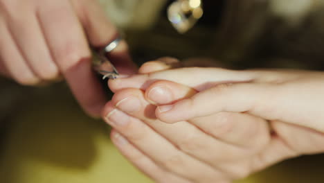 Mom-Cuts-Nails-On-Her-Daughter\'s-Hand-Close-Up-4K-Video