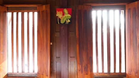 wooden window gradually opening, sunlight streaming in