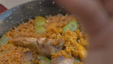 Woman-having-meal-with-traditional-Spanish-paella