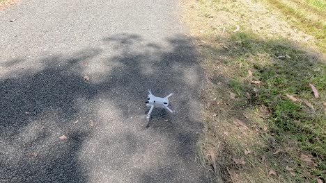 a drone takes off on a rural road