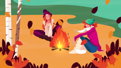 two women enjoying a campfire in autumn