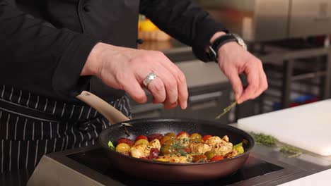 chef preparing a chicken and vegetable dish