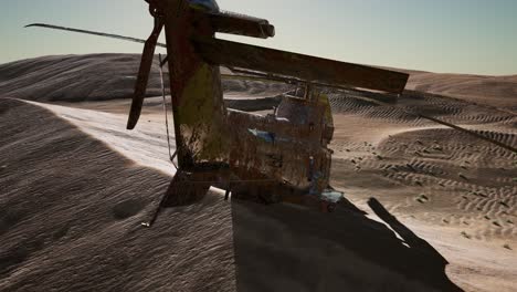 old rusted military helicopter in the desert at sunset