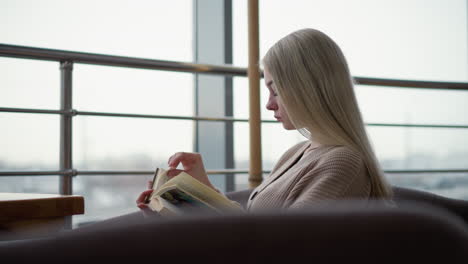 side view of lady deeply studying, focused on reading from an open book, calmly immersed in her thoughts, with a serene and contemplative expression