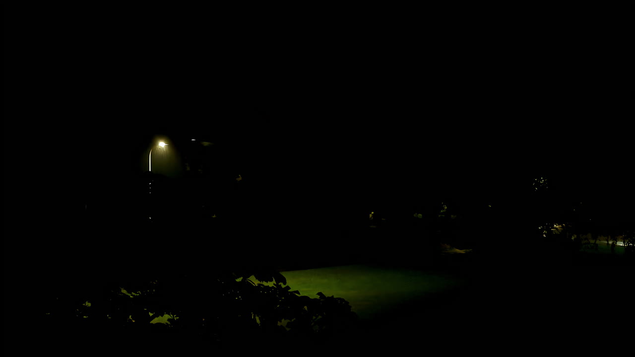 Lightning bolts illuminate sky during night thunderstorm over residential area