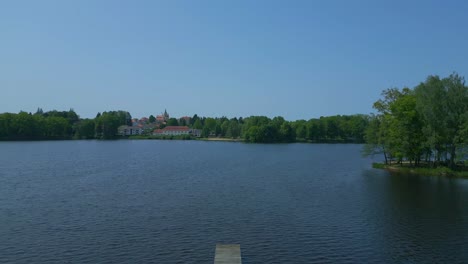 wooden jetty dramatic aerial top view flight vacation paradise village chlum at lake hejtman in czech summer day 2023