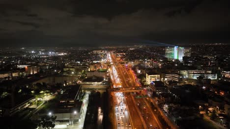 aerial footage of an urban highway with traffic at night