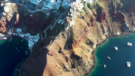 amazing video of famous white and colourful picturesque village of oia built on a cliff during sunset, santorini island, cyclades, greece