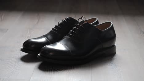 close up shot of black formal shiny shoes placed for wedding ceremony