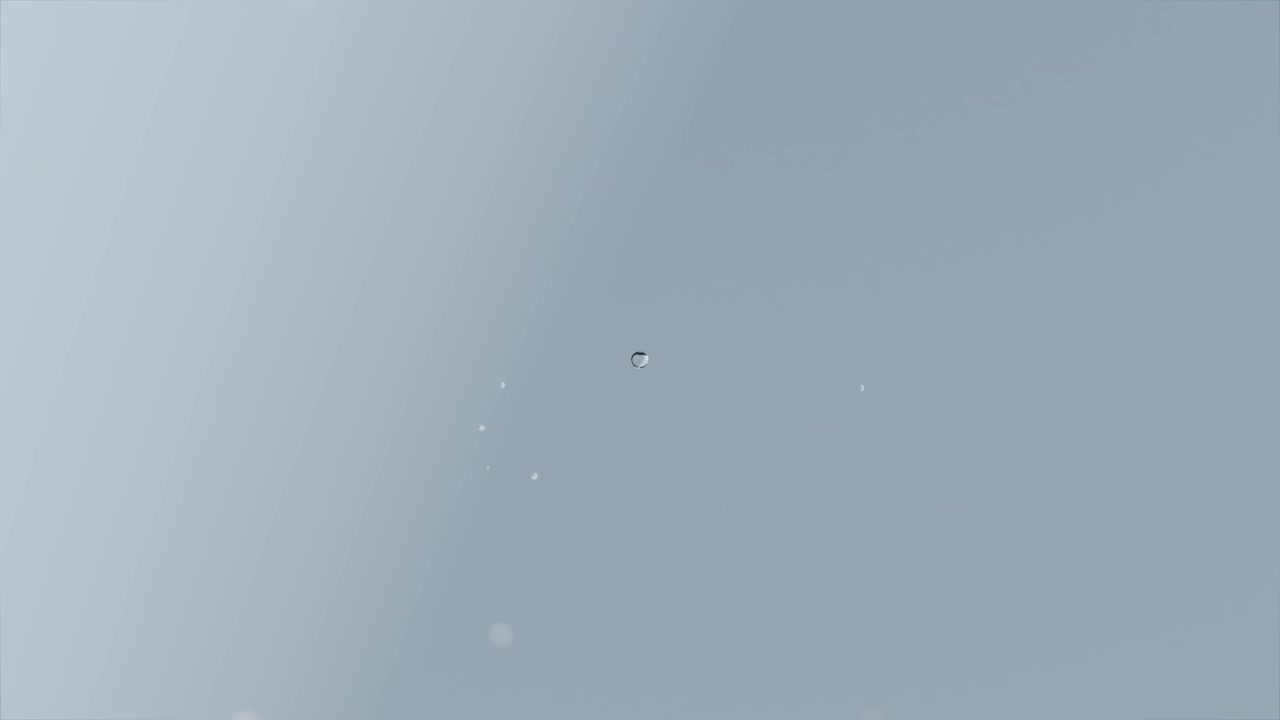 Brightening frame leading tiny bright specks coalescing into single droplet with bokeh, fading back