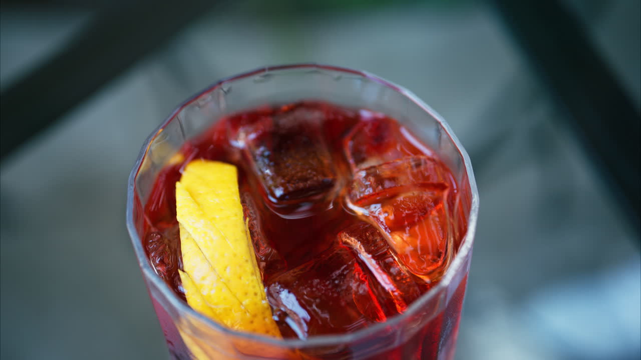 Close up of a Negroni cocktail on a table at a terrace