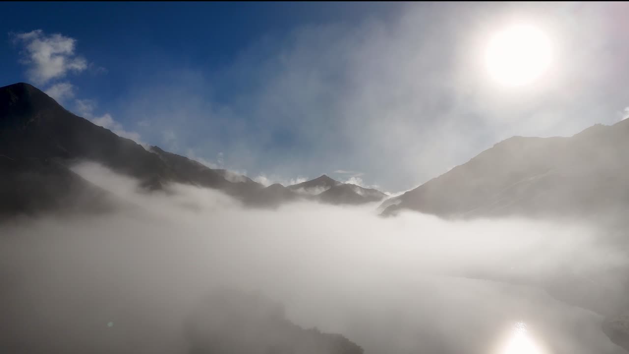 Animation reveals a serene mountain landscape through an airplane window, transitioning from interior to expansive sky view